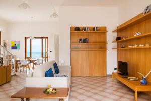a living room with a couch and a table at Villa Elvira - Apulian Stay Group in Faccia di Trippa
