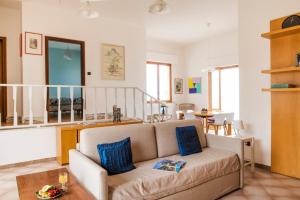 a living room with a couch and a table at Villa Elvira - Apulian Stay Group in Faccia di Trippa