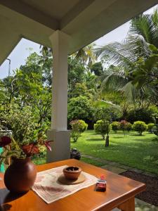 a table with a vase sitting on top of it at Noeline Villa in Bentota