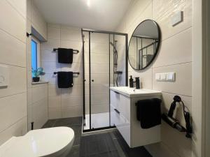 a bathroom with a toilet and a sink and a mirror at Ferienpark Worpswede in Worpswede +70 photos