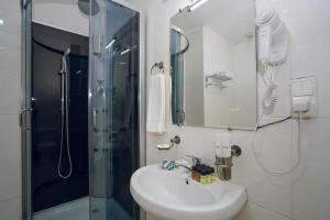 a bathroom with a sink and a shower at Sport time Hotel & Spa in Tbilisi City +25 photos