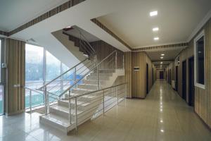 an empty hallway with stairs in a building at Sport time Hotel & Spa in Tbilisi City