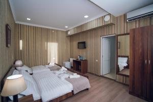 a bedroom with a large bed and a mirror at Sport time Hotel & Spa in Tbilisi City