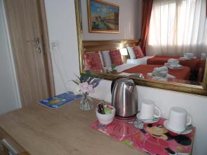 a hotel room with a bed and a table with a mirror at Hotel Tito in Mestre +23 photos