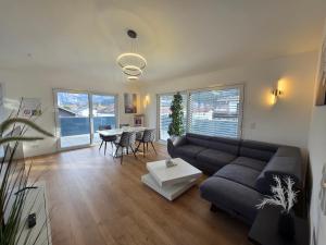 a living room with a couch and a table at Panorama Penthouse in Füssen