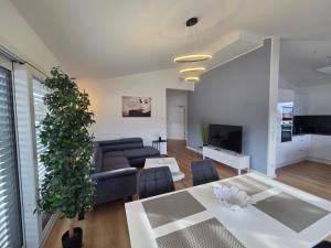 a living room with a couch and a table at Panorama Penthouse in Füssen