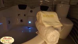 a bathroom with a bath tub with a towel on it at Aladdin Hotel Beer Sheva in Beer Sheva +59 photos