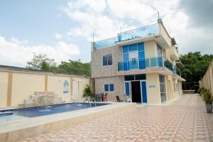 a house with a swimming pool next to a building at Cabanas Villa Antonella Covenas in Coveñas