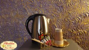 a coffee pot sitting on top of a table at Aladdin Hotel Beer Sheva in Beer Sheva