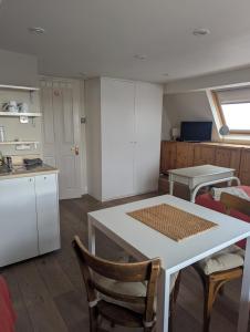 a kitchen with a table and chairs in a room at Brookview Guest House in London