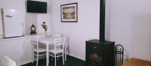 a kitchen with a table and a stove in a room at Ubytovani Sarka in Čistá