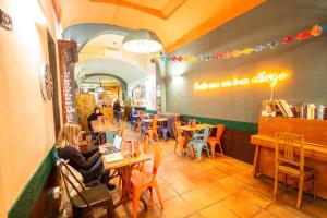 a restaurant with people sitting at tables with laptops at Ostello Bello Firenze in Florence +58 photos