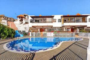 a swimming pool in front of a house at Seaview Oasis Luxury Duplex La Caleta in Adeje +10 photos