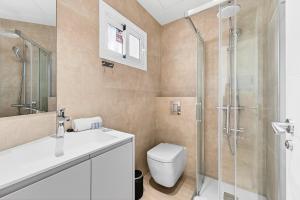 a bathroom with a toilet sink and a shower at Seaview Oasis Luxury Duplex La Caleta in Adeje