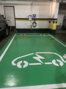 a gym with a green floor and a car parked at Hotel Flat Petras Residence in Curitiba +66 photos