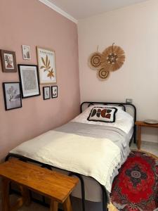 a small bedroom with a bed and a table at 4 Seasons Apartment in Leskovik