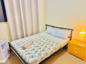 a bedroom with a bed with a pillow and a nightstand at Affordable accommodation in Perth