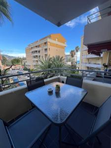 a blue table and chairs on a balcony at One minute to the Beach in Menton