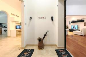 a living room with a guitar on the wall at Ele Home in Siena