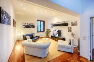 a living room with a couch and a tv at Ele Home in Siena +43 photos