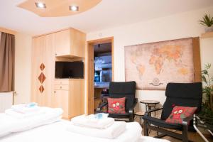 a living room with two chairs and a map on the wall at Four Seasons Lodge in Lackenhof