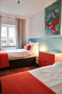 a bedroom with two beds and a painting on the wall at Haus-Selma in Lüneburg
