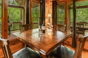 a bottle of wine sitting on a wooden table in a cabin at Smoky Elk in Whittier +10 photos