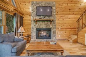 a living room with a fireplace and a tv at Smoky Elk in Whittier