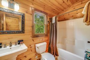 a wooden bathroom with a toilet and a sink at Smoky Elk in Whittier