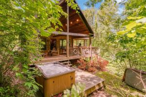 a tree house with a hot tub in the woods at Smoky Elk in Whittier