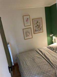 a bedroom with a bed and pictures on the wall at Coquelicot in Waulsort