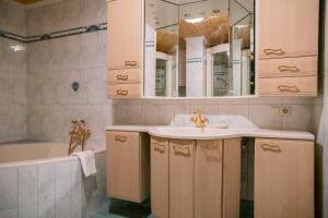 a bathroom with a sink and a tub and a mirror at Four Seasons Lodge in Lackenhof +72 photos
