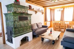 a living room with a fireplace with a couch and a table at Four Seasons Lodge in Lackenhof