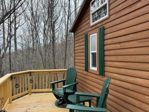 two chairs sitting on a deck of a cabin at Quiet Mountain Top, Pet Friendly, Private Deck in Boone
