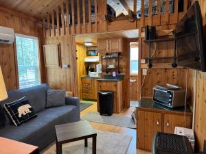 a living room with a couch and a kitchen at Quiet Mountain Top, Pet Friendly, Private Deck in Boone