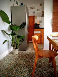 a kitchen with a table and a chair and a refrigerator at Apartamento Trasiego in Valdepeñas +30 photos