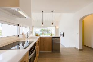 a kitchen with a sink and a dishwasher at Villas Etnia in Binissafuller