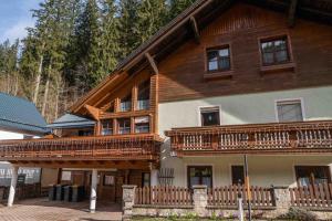 a large wooden house with a wooden balcony at Four Seasons Lodge in Lackenhof