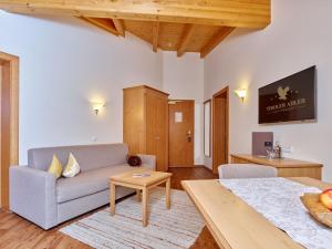a living room with a couch and a table at Alp Resort Tiroler Adler in Sölden +85 photos