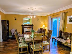 a dining room with a table and chairs at Cloonacauneen House in Balnacart