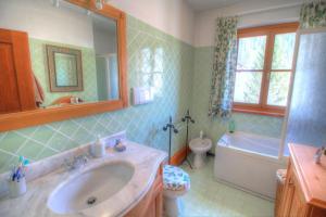 a bathroom with a sink and a tub and a toilet at Botton d'oro in Borca di Cadore