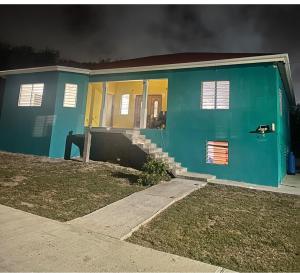 a blue house with a fire in it at Hector residence in Saint Johnʼs