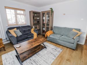 a living room with two couches and a coffee table at 3 Leycester Court in Warwick