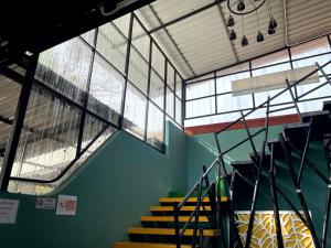 a group of stairs in a building with windows at Green Gen Hotel Phuket in Phuket