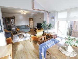a living room with a couch and a table at 3 Leycester Court in Warwick