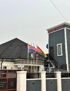 a building with two flags in front of it at Moor Times Hotel in Benin City
