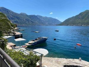 a boat is docked in a large body of water at Boka Bay Beach House in Dražin Vrt