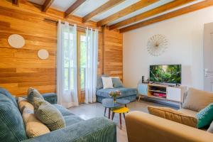 a living room with a couch and a tv at Barbadine974, Chalet cosy, 6 personnes, Plaine des Cafres in La Plaine des Cafres