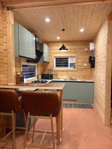 a kitchen with a table and chairs in a room at Samlaun Chalet and Retreat in Kanatal