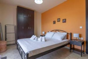 a bedroom with a large bed with white pillows at Villa ELENA in Alexandroupoli